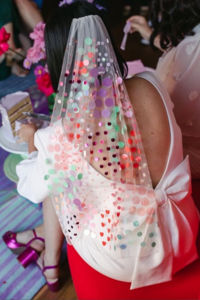 bride wearing white veil with multicolored sequins